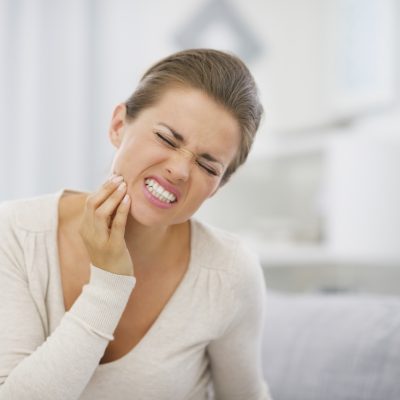 Portrait of young woman with toothache Portrait of young woman with toothache